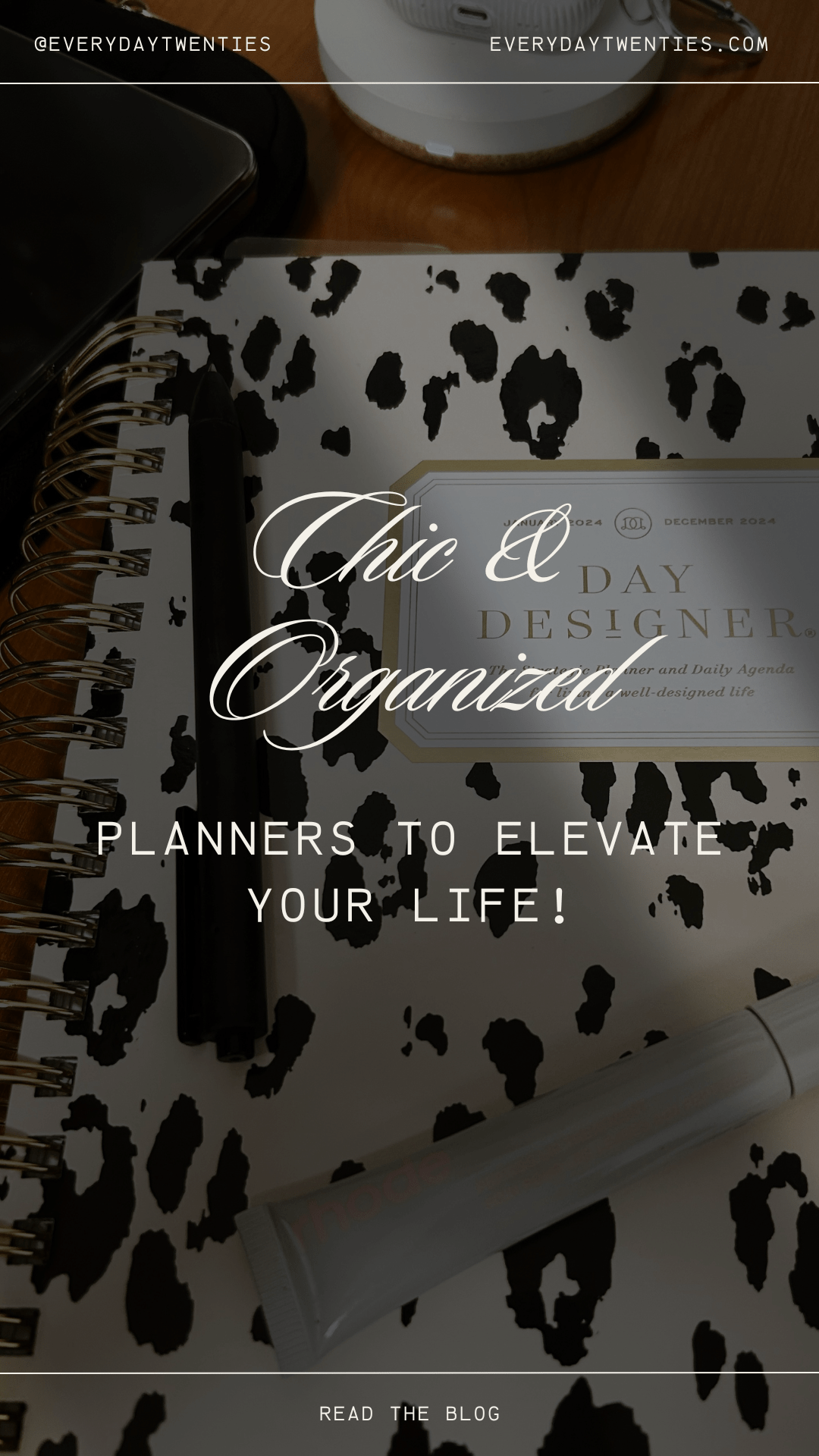 a day designer daily planner with a pen and a rhode lip peptide on it